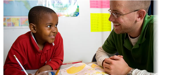 A Virginia Tech student participating in Homework Help with a Somali Bantu child at the Pilot Street Project in Roanoke, VA; a project sponsored by the Center for Student Engagement and Community Partnerships.