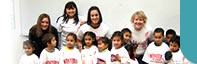 Western Oregon University (WOU) Students with Latino children enrolled in a preschool program called Lecturas en Familia (Family Readings). This is a program developed by the Farmworker Housing Development Corporation at Colonia Amistad in Independence, OR.  On this day, WOU students taught a lesson plan that included painting WOU shirts donated by the WOU bookstore.  